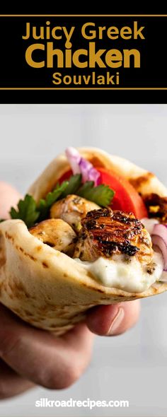 a hand holding a pita sandwich with chicken and vegetables on it in front of the text juicy greek chicken souvlaki