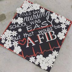 a decorated graduation cap that says i could say nursing was easy but that would be aa - fib