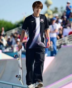 a young man riding a skateboard up the side of a ramp at a skate park