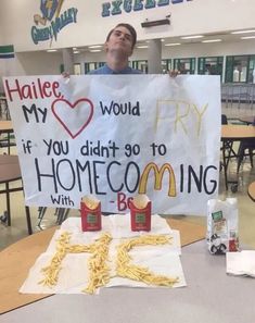 a man holding up a sign that says, i love my world if you didn't go to home cooking with fries