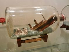 a model ship in a glass bottle on display