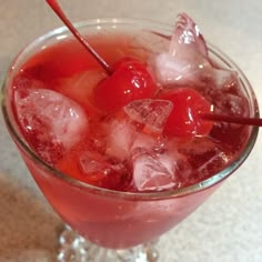 a glass filled with ice and cherries