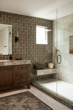 a bathroom with a sink, mirror and bathtub next to a walk in shower