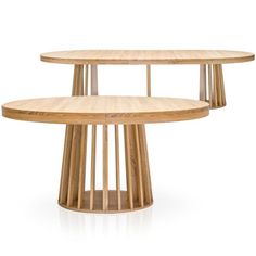 two circular wooden tables sitting next to each other