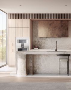 a modern kitchen with marble counter tops and wooden cabinetry, along with stools