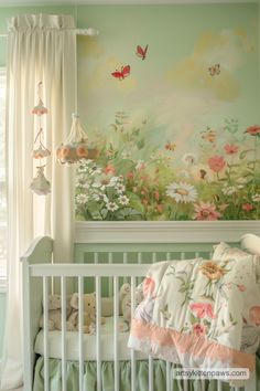 a baby's room decorated in pastel green and white with butterflies on the wall