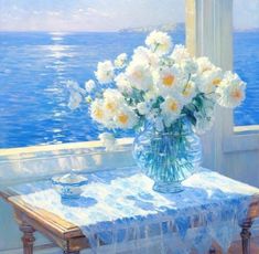 a painting of white flowers in a vase on a table near the ocean and water