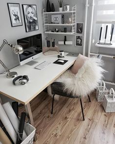 a white desk topped with a computer monitor next to a chair and shelf filled with books