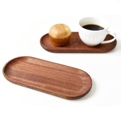 two wooden trays with coffee and muffin on them