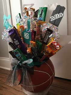 a basket filled with assorted candy and candies on top of a wooden floor