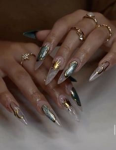 a woman's hands with gold and silver nails