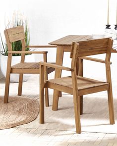 two wooden chairs sitting next to each other on top of a white carpeted floor