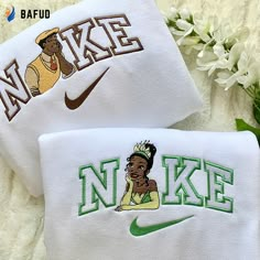 two white towels with the words nike and a cartoon image of a woman on them