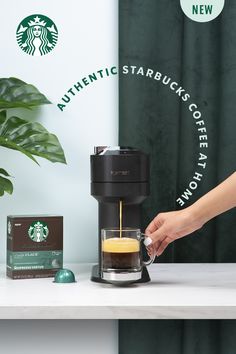 a starbucks coffee maker being filled with liquid