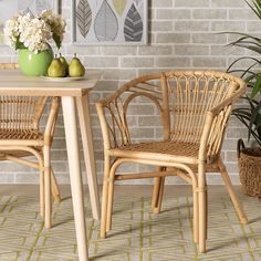 two wicker chairs sitting next to each other near a table with fruit on it