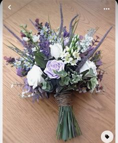 a bouquet of flowers sitting on top of a wooden table next to an instagram page