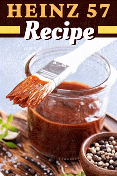 a jar filled with brown sauce next to a wooden bowl full of beans and spices