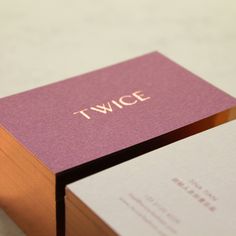 two business cards sitting on top of each other next to one another with the word twice printed on them