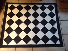 a black and white checkerboard pattern on the floor in a room with tile floors