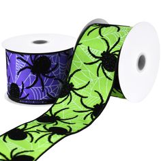 two rolls of spider web on green and purple ribbon with black dots, spooked