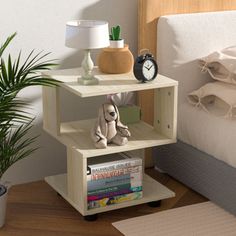 a bed with a lamp and a book shelf on top of it next to a plant