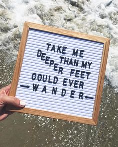 a hand holding up a sign that says take me deeper my squid ever wander