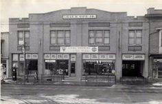 an old black and white photo of a store front