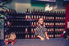 a woman standing behind a counter in a store