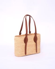 this stunning raffia handmade bag to our customers. This versatile bag can be used as both a shoulder bag and a handbag, making it the perfect accessory for any woman. The natural and eco-friendly raffia material used in this bag makes it a great choice for those who value sustainability. The bag comes in natural raffia color and black , so you can choose the one that best suits your personal style. Our skilled artisans have crafted this bag with traditional techniques and attention to detail, e Natural Fiber Shoulder Bag For Vacation, Chic Woven Natural Fiber Shoulder Bag, Adjustable Strap Beach Bag Made Of Natural Fiber, Chic Woven Leather Shoulder Bag, Chic Natural Shoulder Bag With Leather Handles, Handwoven Double Handle Shoulder Bag For Vacation, Vacation Handwoven Shoulder Bag With Double Handle, Natural Summer Shoulder Bag In Natural Fiber, Rectangular Palm Leaf Beach Bag For Travel