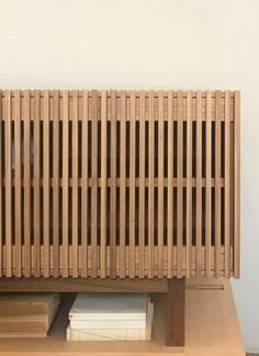 a wooden bench sitting on top of a table next to a book shelf with books