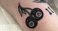 a tattoo with two black and white billiards on it