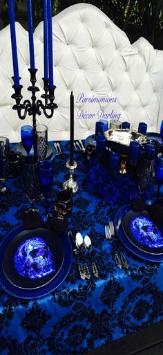 a table set with blue and black place settings