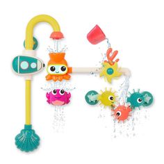 an assortment of toys that are in the shape of sea animals, including a water sprinkler