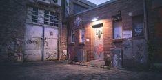 an alleyway with graffiti on the walls and door to another building in the background