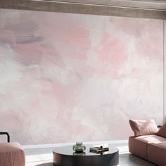 a living room with two couches and a coffee table in front of a pink painted wall