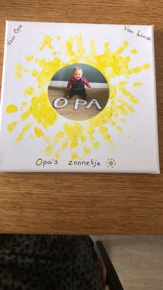 a child's photo on a card with yellow paint splattered over it