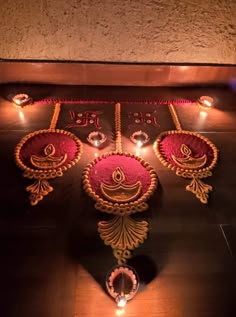 an intricately decorated diya with candles on the floor