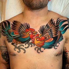 a man with a tattoo on his chest and two birds in the middle of it