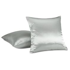 two silver pillows sitting next to each other