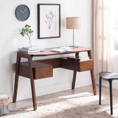 a wooden desk with two drawers under a clock on the wall next to a window