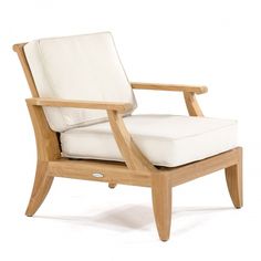 a wooden chair with a white cushion on it's back and armrests