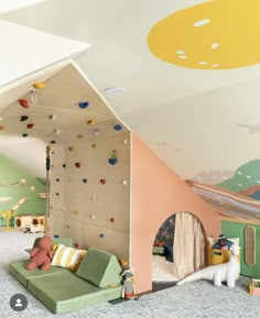 a child's bedroom with climbing wall and play area in the corner is shown