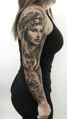 a woman with a tattoo on her arm is posing for the camera and has a wolf behind her head