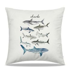 a white pillow with sharks on it and the words shark in black ink above them