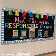 a bulletin board with colorful tassels on it