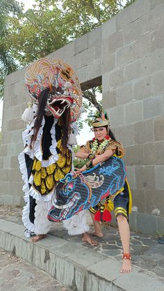 two people dressed in costumes standing next to each other