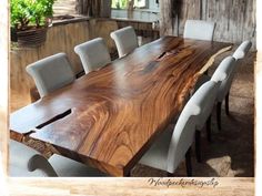 a large wooden table with white chairs around it