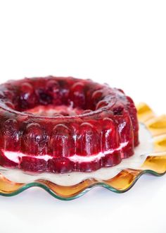 a jelly cake sitting on top of a glass plate