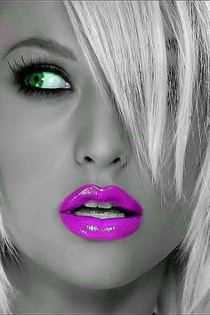 a woman with bright pink lipstick and green eyes