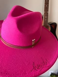 Make a statement with the Howdy hat! This hot pink, dolly parton inspired style is the perfect way to introduce some western flair into your wardrobe. The unique howdy detail will make sure you stand out in a crowd! The hot pink howdy hat is the perfect addition to your western wardrobe Western Pink Hat With Curved Brim, Western Style Pink Hat With Curved Brim, Pink Wide Brim Hat For Rodeo, Pink Brimmed Hat For Rodeo, Pink Curved Brim Hat For Rodeo, Pink Western Felt Hat With Curved Brim, Pink Western Style Felt Hat With Curved Brim, Pink Fitted Hat For Rodeo, Pink Flat Brim Hat For Country Events